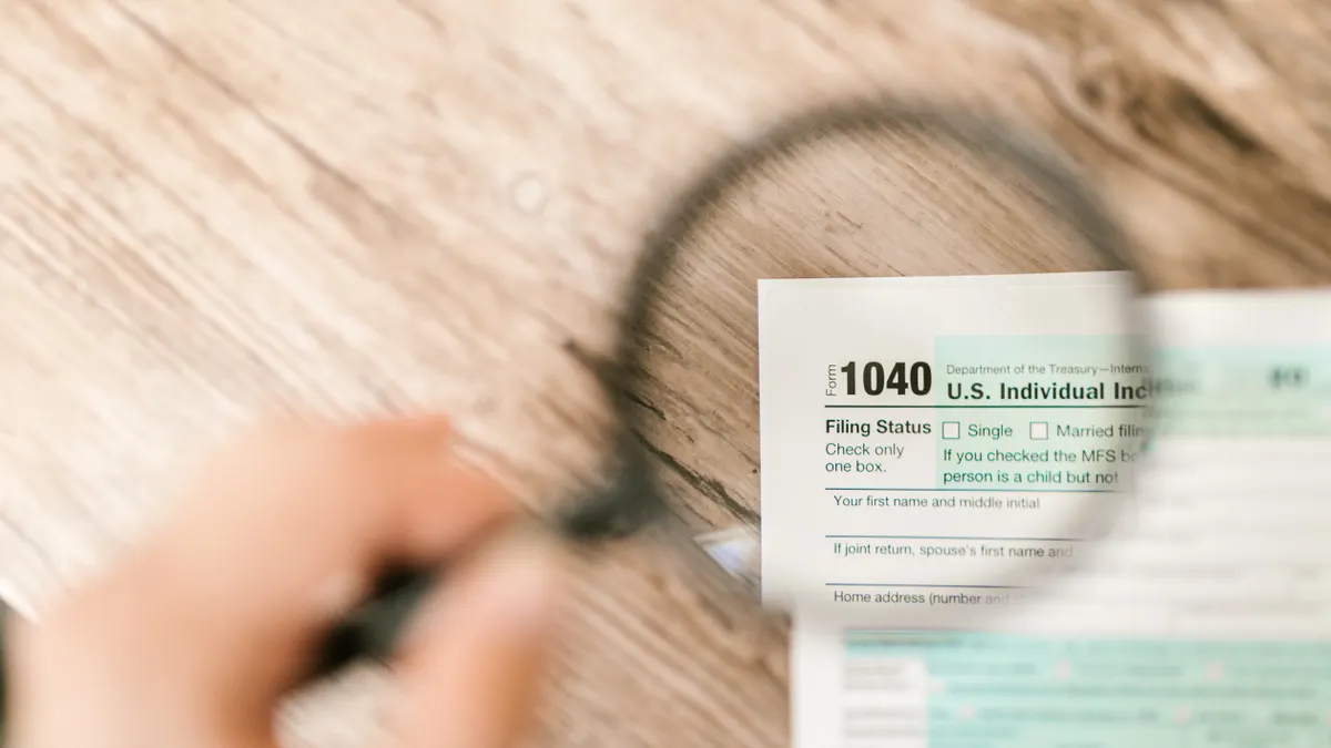 2026 federal income tax brackets explained Magnifying glass over a 1040 tax form
