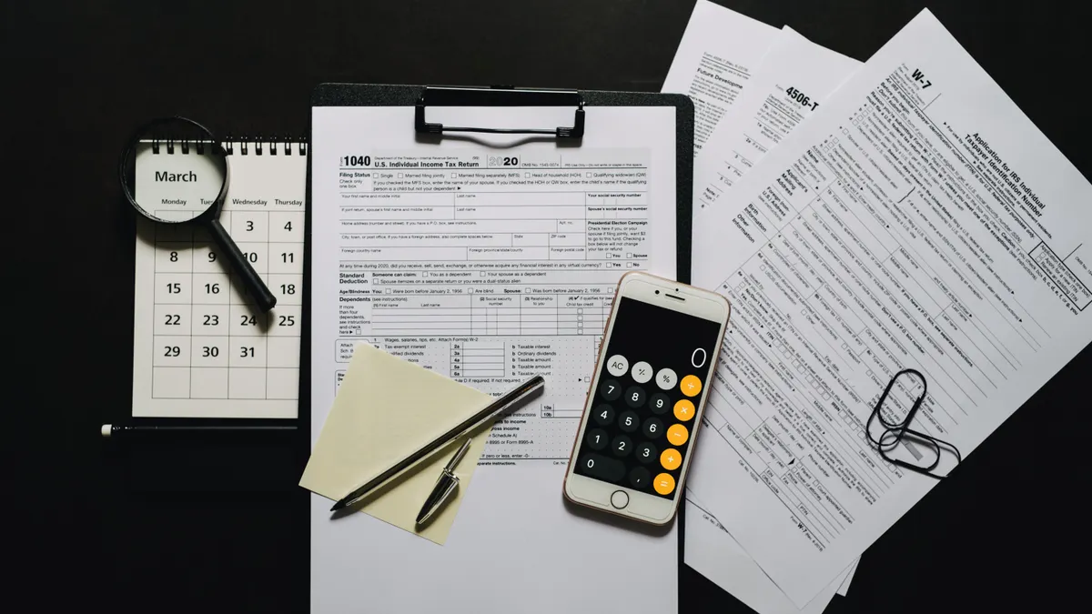 Earned Income Tax Credit: eligibility basics Tax paperwork with calculator and calendar